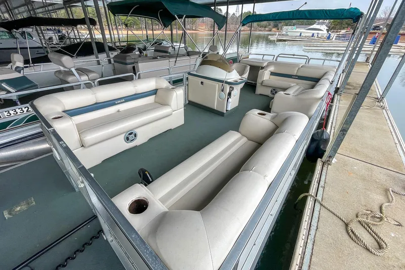 Slide: The Image of 2000 Crest 25' Pontoon boat with spacious seating, docked at a marina. - 7