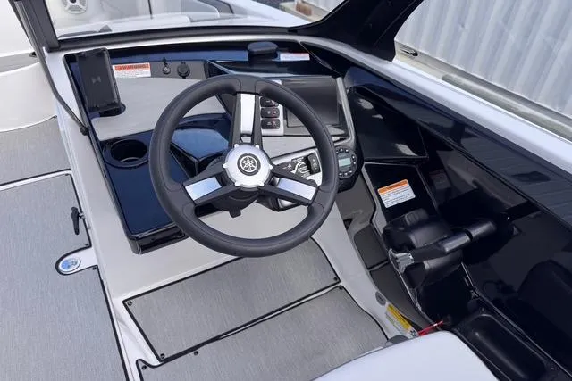 Slide: The Image of 2023 Yamaha Boats AR220 cockpit with steering wheel and control panel. - 7