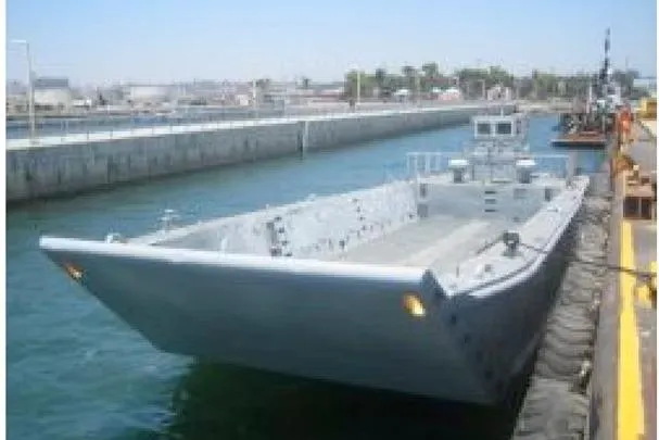 Slide: The Image of 1987 Commercial LCU 8 landing craft docked at a harbor. - 5