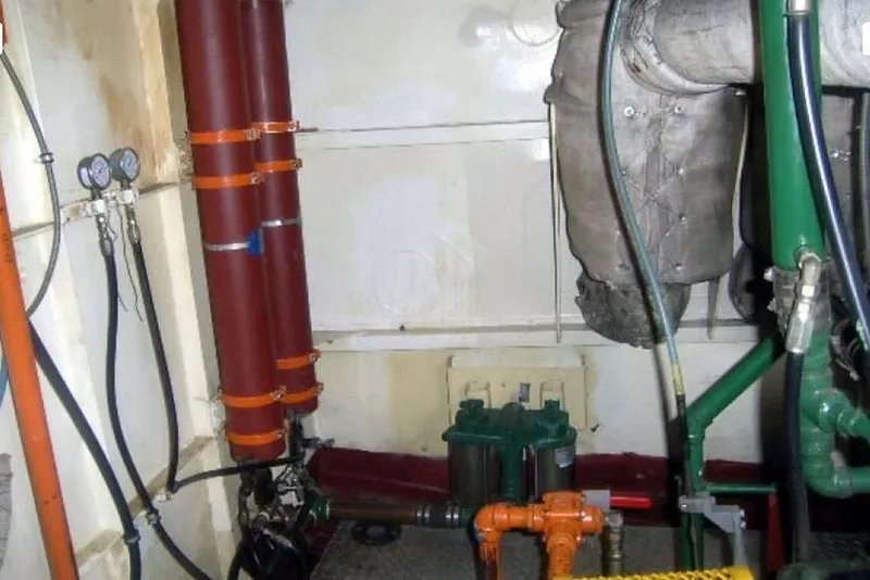 Slide: The Image of Engine room of 1987 Commercial LCU 8 with pipes, gauges, and machinery components. - 8