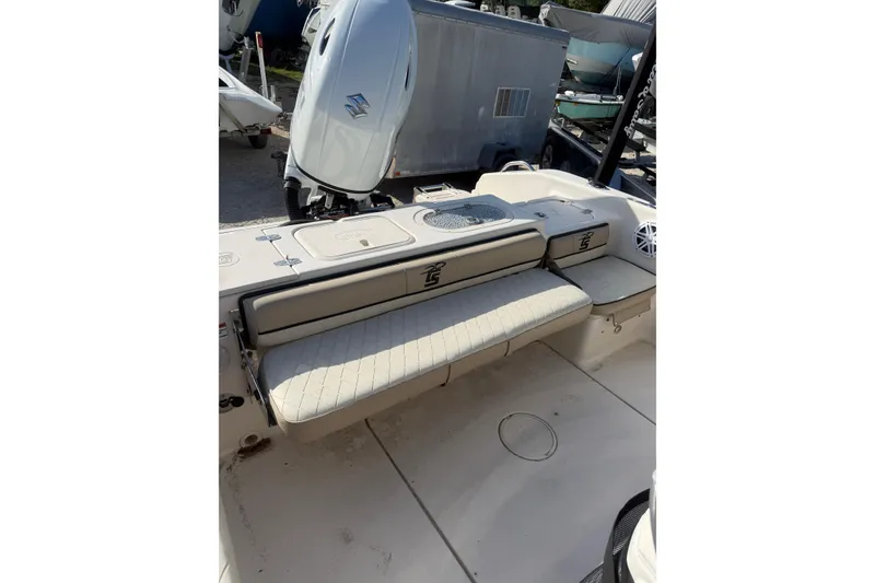 Slide: The Image of 2022 Carolina Skiff 23 UE boat interior with seating and Suzuki outboard motor. - 16