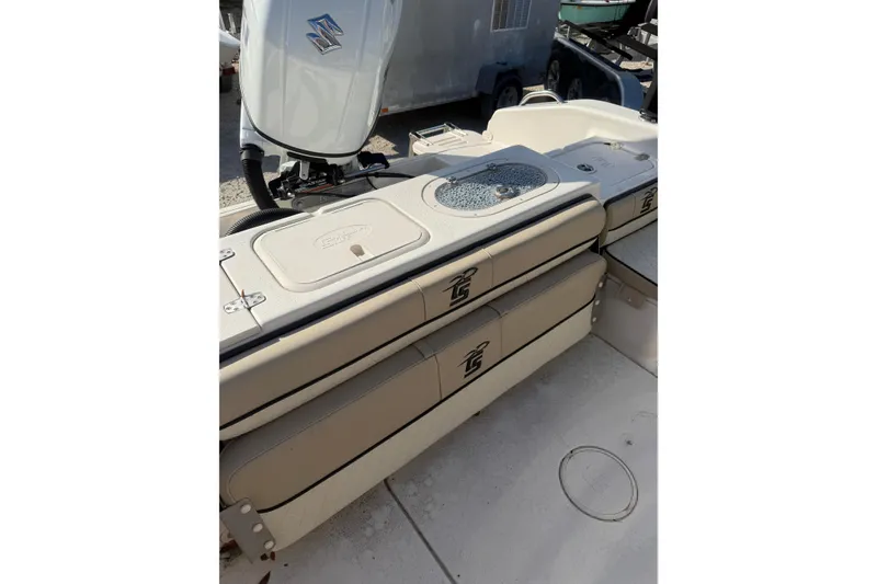 Slide: The Image of 2022 Carolina Skiff 23 UE boat interior with storage compartments and motor. - 17