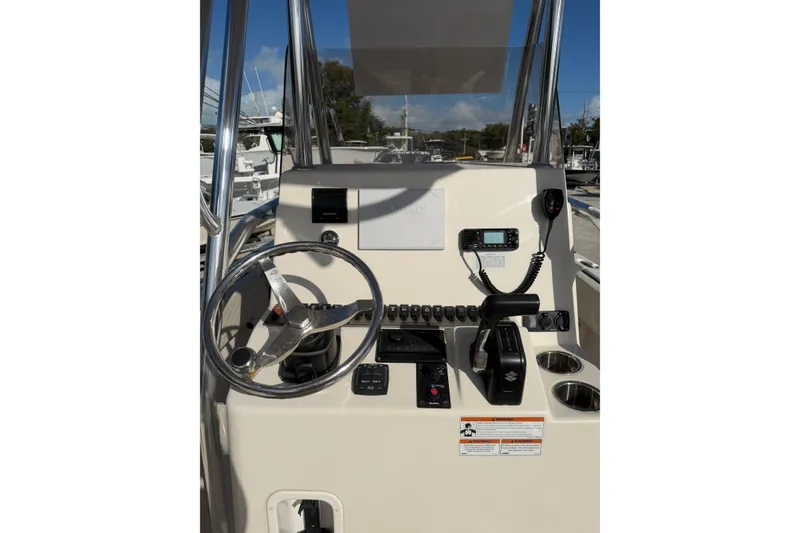 Slide: The Image of 2022 Carolina Skiff 23 UE boat console with steering wheel and controls. - 19