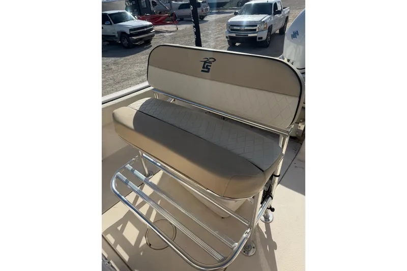 Slide: The Image of 2022 Carolina Skiff 23 UE boat seat with beige upholstery and chrome frame. - 20