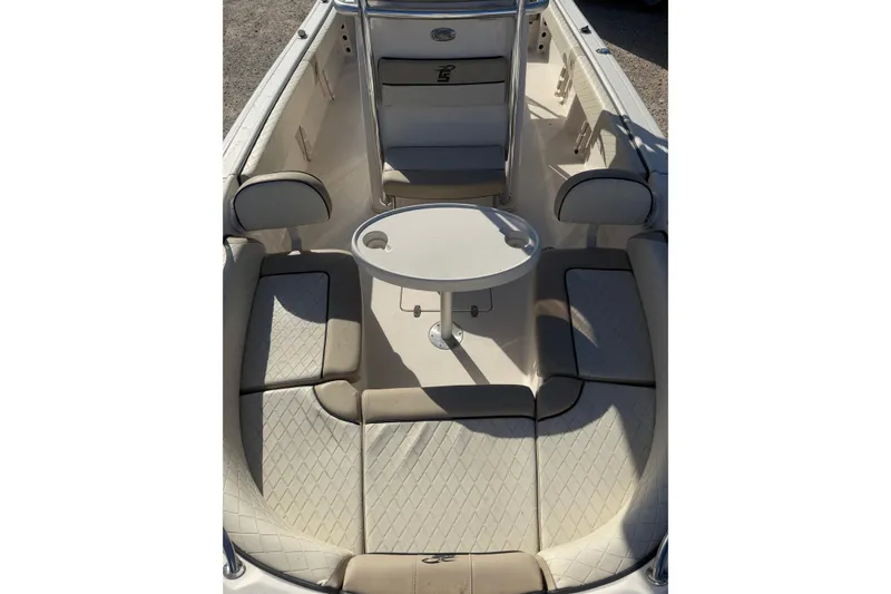 Slide: The Image of 2022 Carolina Skiff 23 UE boat interior with cushioned seating and round table. - 25