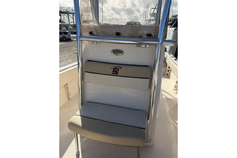 Slide: The Image of 2022 Carolina Skiff 23 UE boat interior with cushioned seating and stainless steel railing. - 29