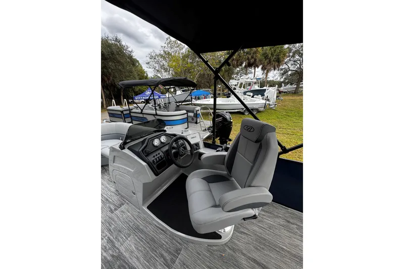 Slide: The Image of 2026 Bentley Pontoons Legacy 243 Swingback interior with captain's chair and control panel. - 3