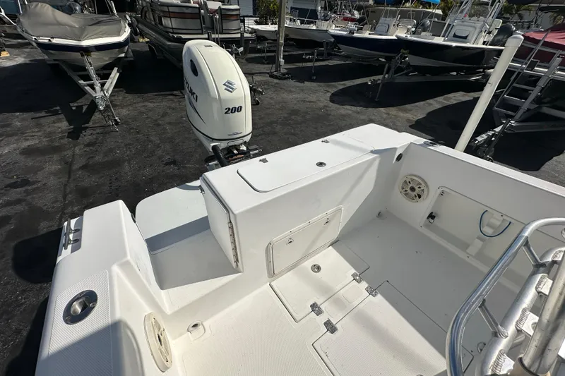 Slide: The Image of 1998 Bluewater 2150 boat with Suzuki 200 outboard motor in a marina setting. - 11
