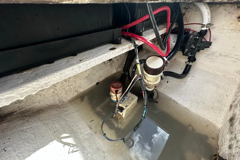 Slide: The Image of Bilge area of 1998 Bluewater 2150 boat with wiring and water accumulation. - 14