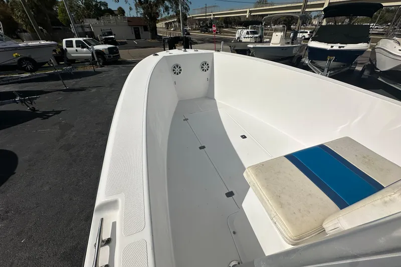 Slide: The Image of 1998 Bluewater 2150 boat interior with seating, docked among other boats. - 7