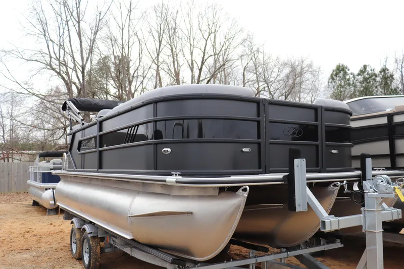 The Image of 2026 Bentley Pontoons 203 BOLT on trailer, sleek black design, parked outdoors. - 0