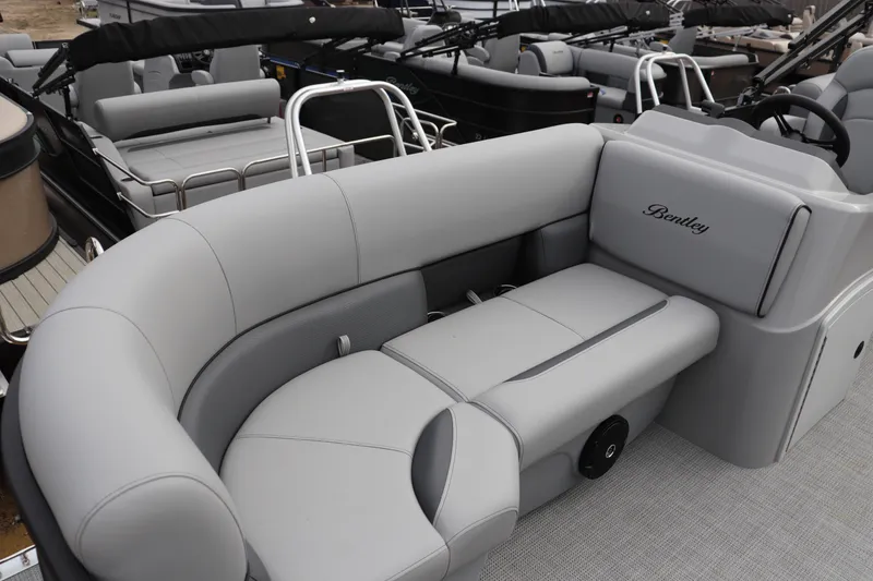 Slide: The Image of 2026 Bentley Pontoons 203 BOLT with luxurious gray seating and sleek design. - 2