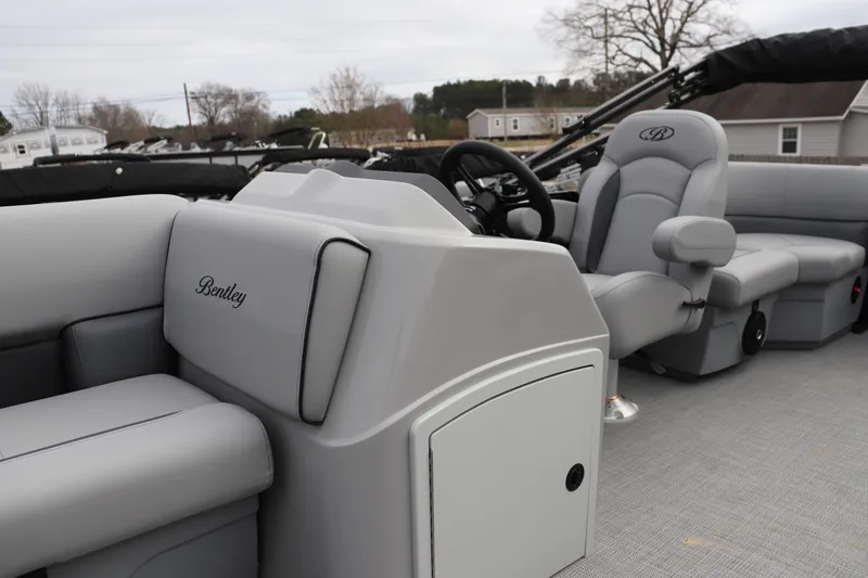 Slide: The Image of 2026 Bentley Pontoons 203 BOLT interior with sleek gray seating and modern steering console. - 4