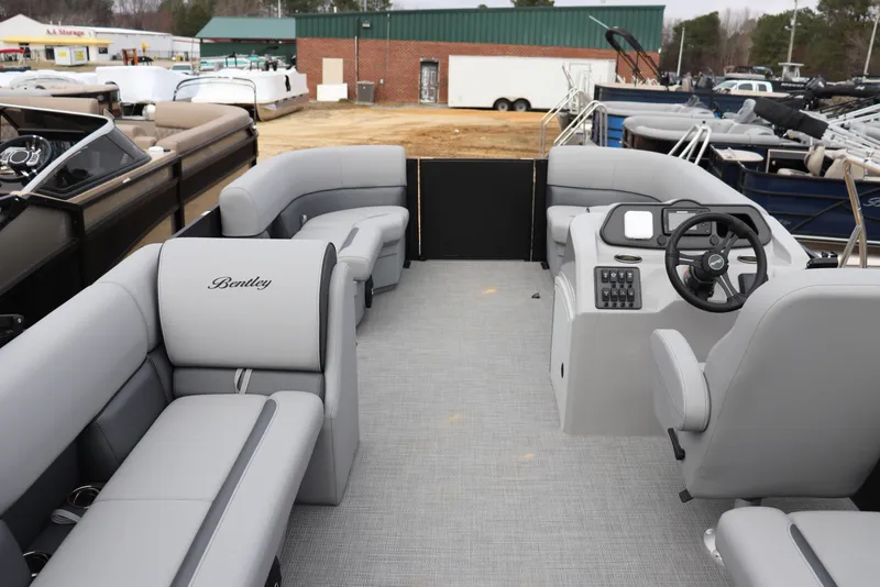 Slide: The Image of 2026 Bentley Pontoons 203 BOLT interior with gray seating and steering console. - 8