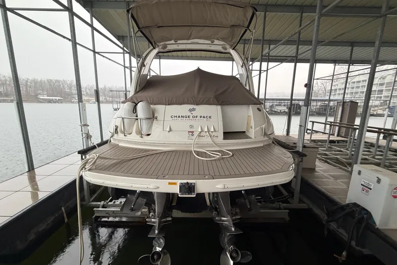 Slide: The Image of 2006 Cruisers Yachts 300 Express docked, rear view with covered deck and twin engines. - 10