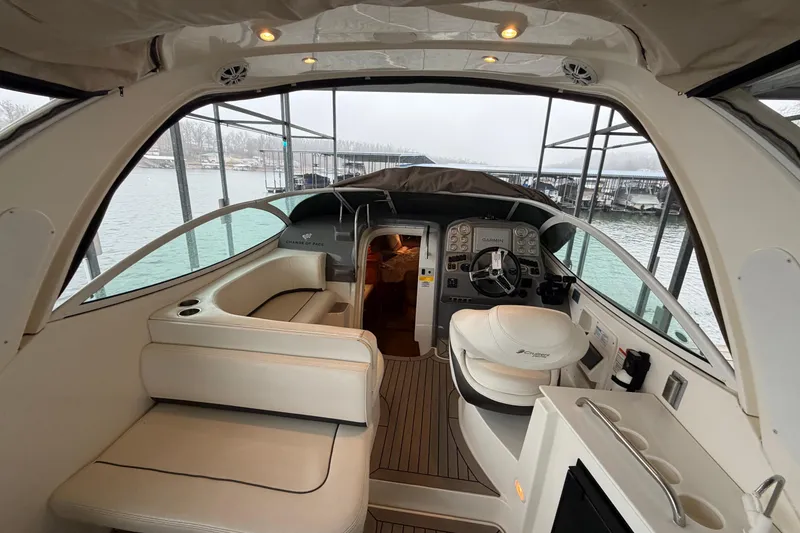 Slide: The Image of 2006 Cruisers Yachts 300 Express interior with helm, seating, and lake view. - 12