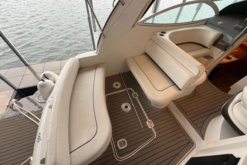 Slide: The Image of 2006 Cruisers Yachts 300 Express interior with white seating and wood flooring. - 13