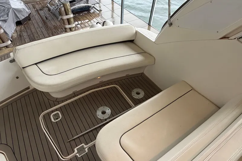 Slide: The Image of 2006 Cruisers Yachts 300 Express interior with beige seating and wooden deck. - 14