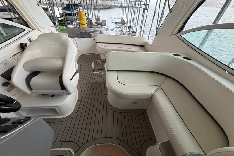 Slide: The Image of 2006 Cruisers Yachts 300 Express interior with white seating and wood flooring. - 15