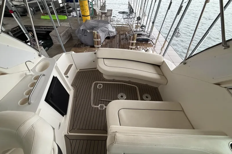 Slide: The Image of 2006 Cruisers Yachts 300 Express interior with white seating and wood flooring. - 17