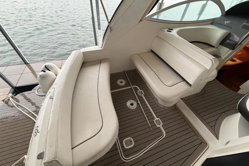 Slide: The Image of 2006 Cruisers Yachts 300 Express interior with white seating and teak flooring. - 18