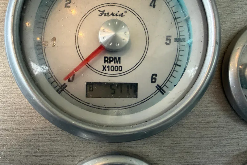 Slide: The Image of Close-up of a 2006 Cruisers Yachts 300 Express RPM gauge showing 511 RPM. - 23