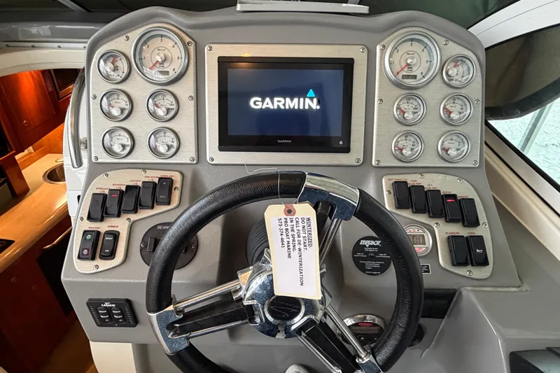 Slide: The Image of 2006 Cruisers Yachts 300 Express dashboard with Garmin display and control gauges. - 24