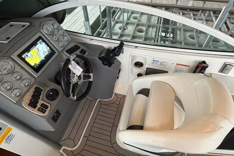 Slide: The Image of 2006 Cruisers Yachts 300 Express helm with navigation system and white captain's chair. - 26