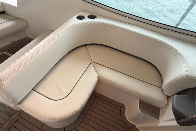 Slide: The Image of 2006 Cruisers Yachts 300 Express interior with white leather seating and cup holders. - 28