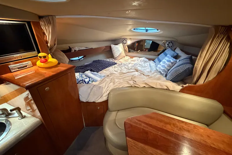 Slide: The Image of Interior of 2006 Cruisers Yachts 300 Express with cozy bed and entertainment area. - 36