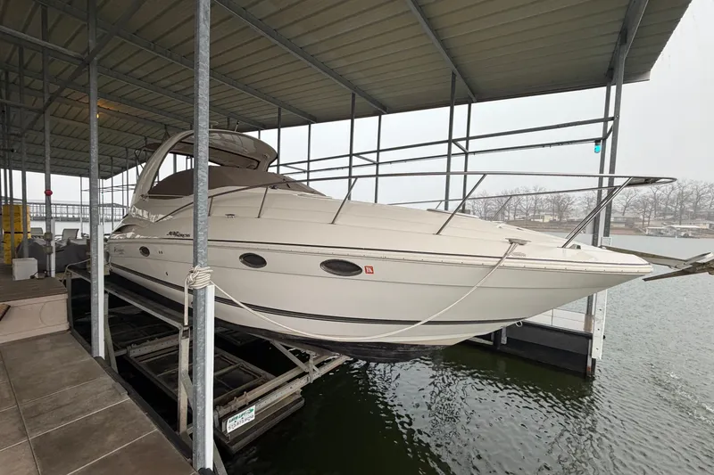 The Image of 2006 Cruisers Yachts 300 Express docked under a covered marina. - 6
