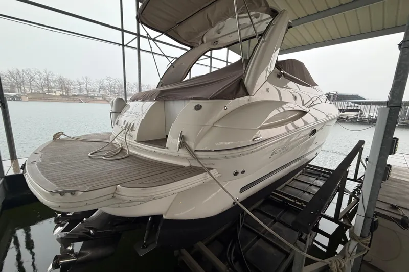 Slide: The Image of 2006 Cruisers Yachts 300 Express docked, showcasing sleek design and spacious deck. - 8