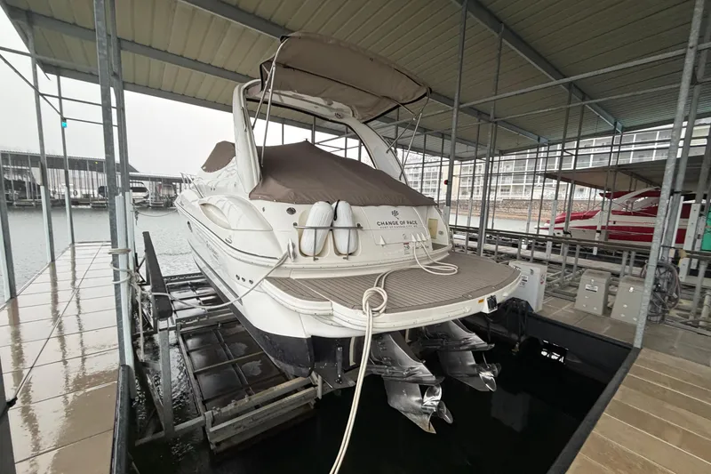 Slide: The Image of 2006 Cruisers Yachts 300 Express docked in covered marina slip. - 9