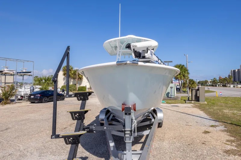 Slide: The Image of 2024 Cape Horn 24 XS boat on trailer, parked outdoors under clear blue sky. - 10