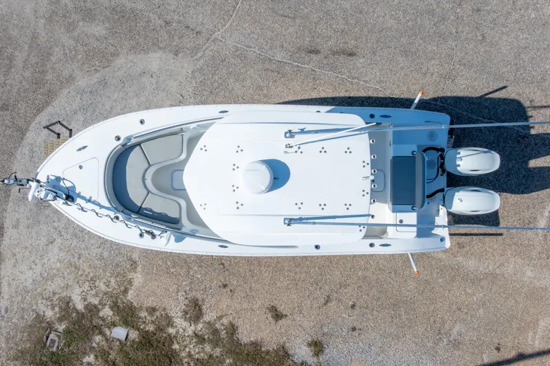 Slide: The Image of Top view of 2024 Cape Horn 24 XS boat with dual engines on gravel surface. - 12