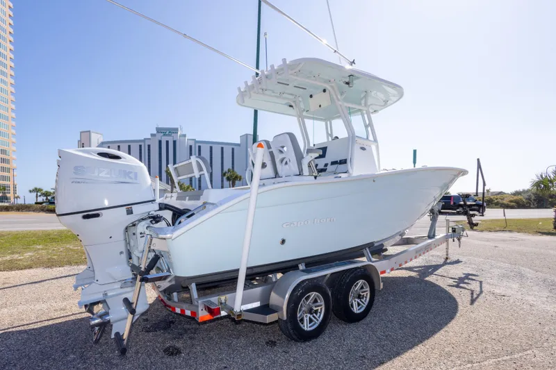 Slide: The Image of 2024 Cape Horn 24 XS boat on trailer with Suzuki engine, parked outdoors. - 14
