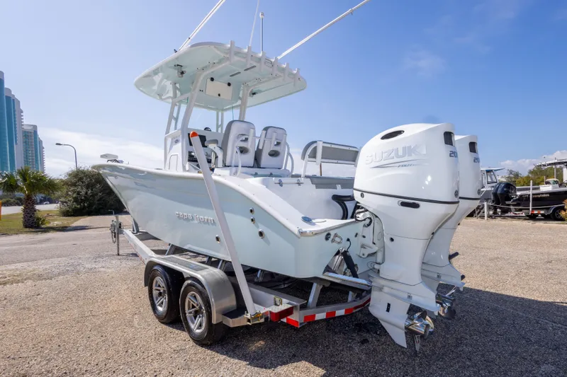 Slide: The Image of 2024 Cape Horn 24 XS boat with dual Suzuki engines on a trailer. - 15