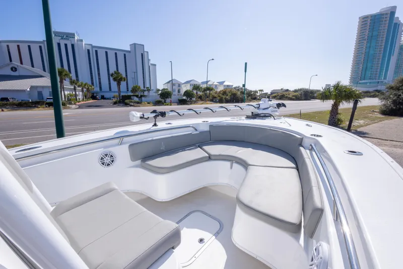 Slide: The Image of 2024 Cape Horn 24 XS boat with spacious seating, docked near modern buildings. - 20