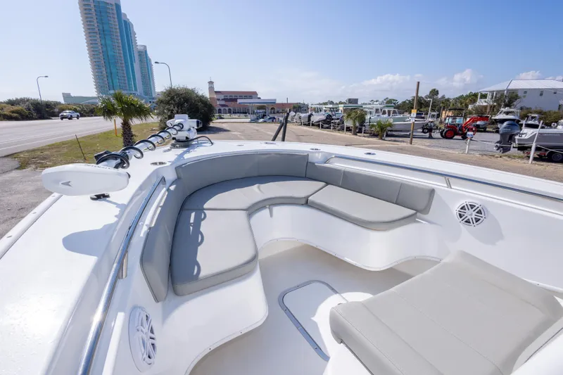 Slide: The Image of 2024 Cape Horn 24 XS boat with spacious seating, docked near a coastal road. - 21