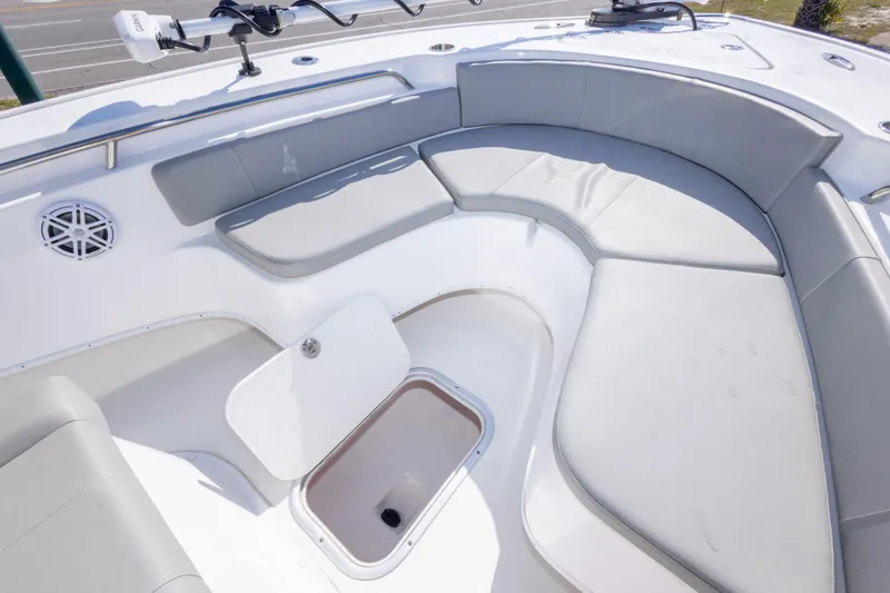 Slide: The Image of 2024 Cape Horn 24 XS boat interior with cushioned seating and storage compartment. - 22