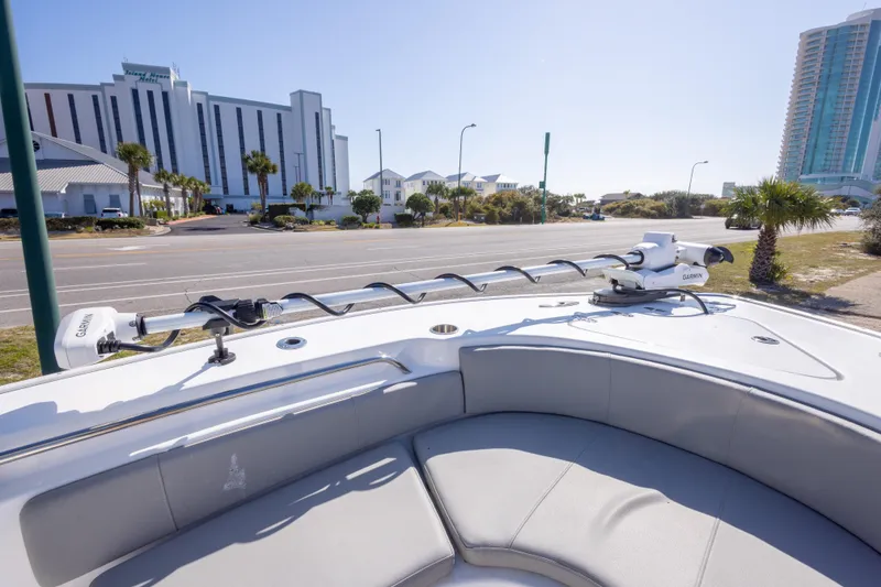 Slide: The Image of 2024 Cape Horn 24 XS boat with Garmin equipment, docked near modern buildings. - 24