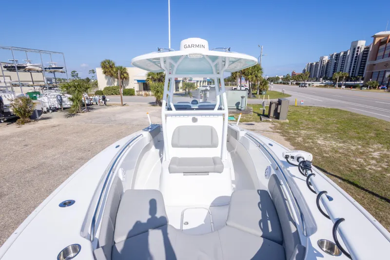 Slide: The Image of 2024 Cape Horn 24 XS boat with Garmin equipment, docked near a coastal road. - 25