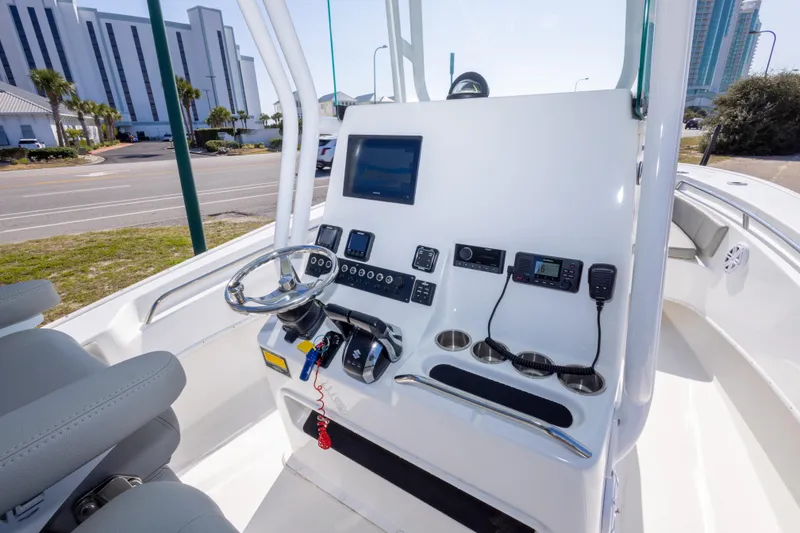 Slide: The Image of 2024 Cape Horn 24 XS boat console with steering wheel and electronic controls. - 29