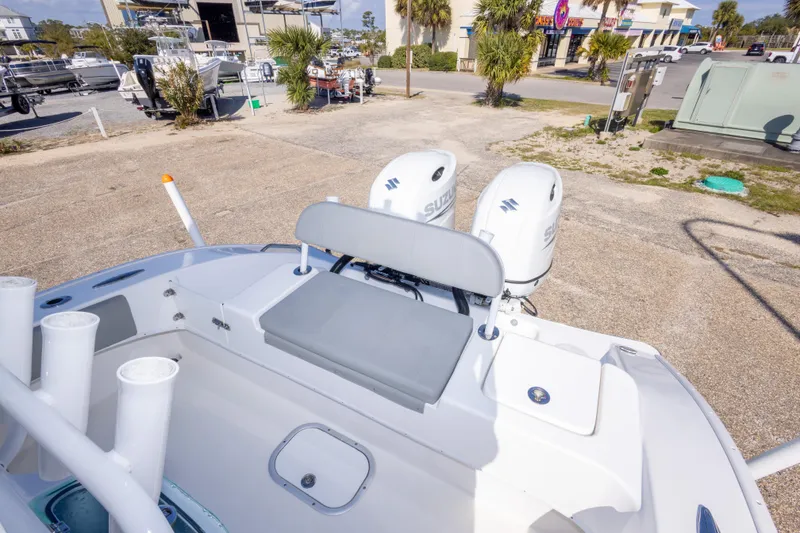 Slide: The Image of 2024 Cape Horn 24 XS boat with dual Suzuki engines, docked outdoors. - 36