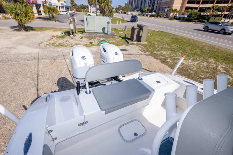 Slide: The Image of 2024 Cape Horn 24 XS boat with dual Suzuki engines, parked near a road. - 37