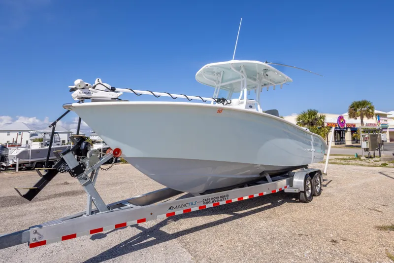 Slide: The Image of 2024 Cape Horn 24 XS boat on trailer, displayed outdoors under clear blue sky. - 8