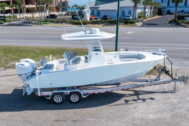 Slide: The Image of 2024 Cape Horn 24 XS boat on trailer, parked near a road. - 9