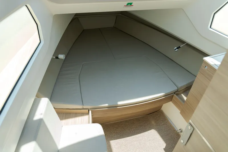 Slide: The Image of Interior of the 2027 Saxdor 320 GTO with cushioned sleeping area and wooden elements. - 17