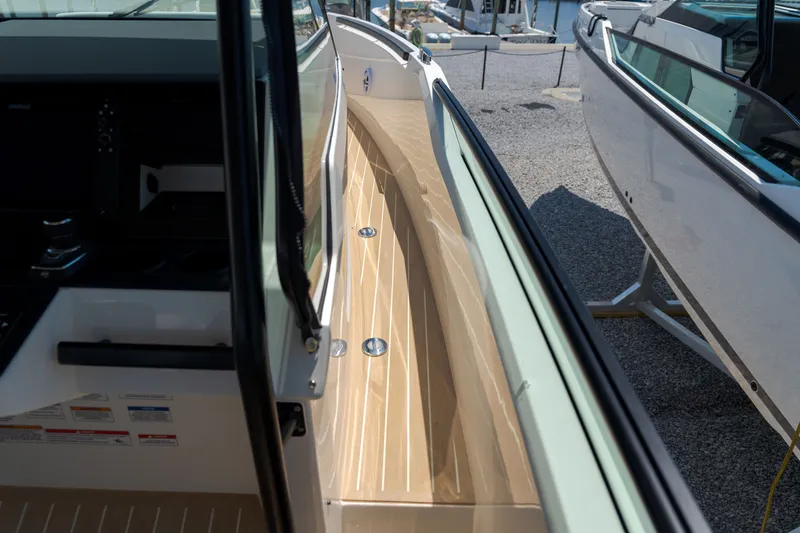 Slide: The Image of The 2027 Saxdor 320 GTO features a modern design with sleek wood details and a spacious deck. - 13