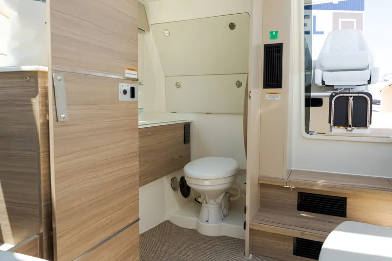 Slide: The Image of Interior of a 2027 Saxdor 320 GTO featuring a modern bathroom with wood accents. - 18